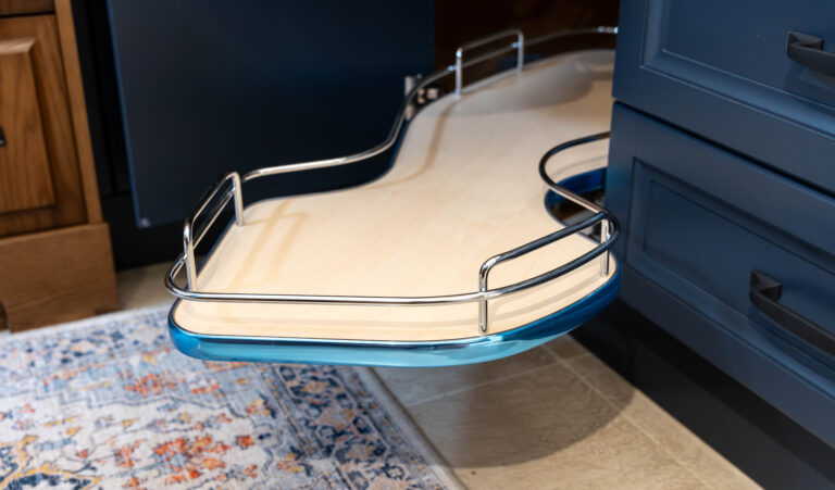 Blue kitchen cabinets expertly hide the lazy susan that makes accessing kitchen essentials easier than ever before.