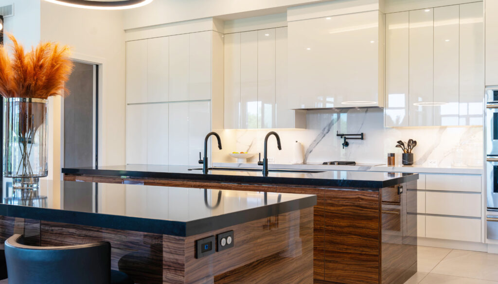 Glossy white kitchen cabinets with wood grain island in Sarnia, Ontario. Design, built and installed by Sarnia Cabinets.