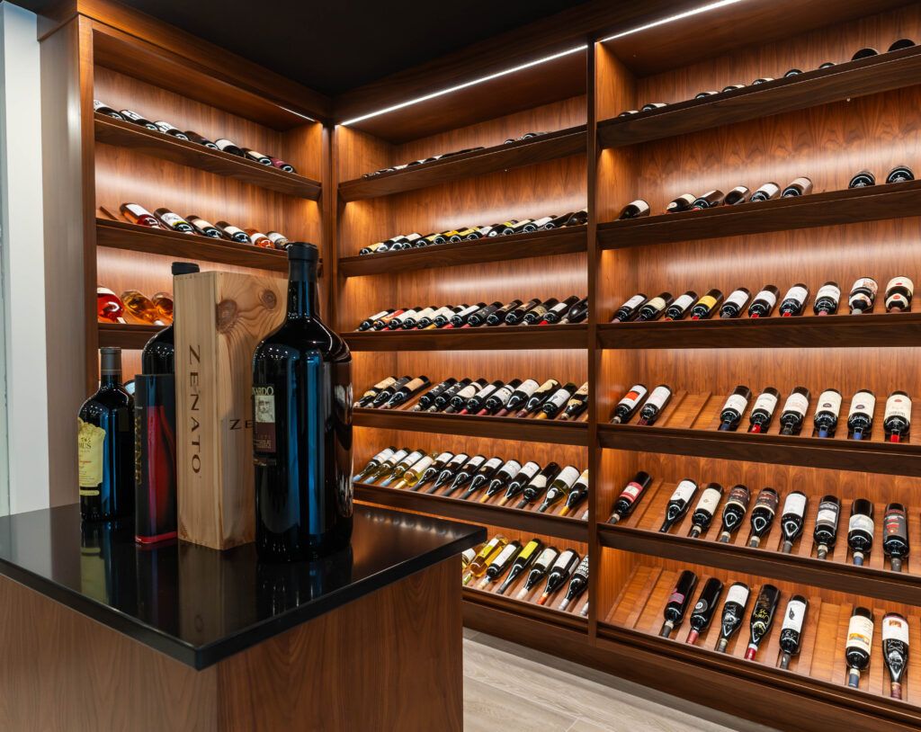 Spacious wine tasting and storage room in Sarnia, Ontario. Includes wood grain finish island. By Sarnia Cabinets.