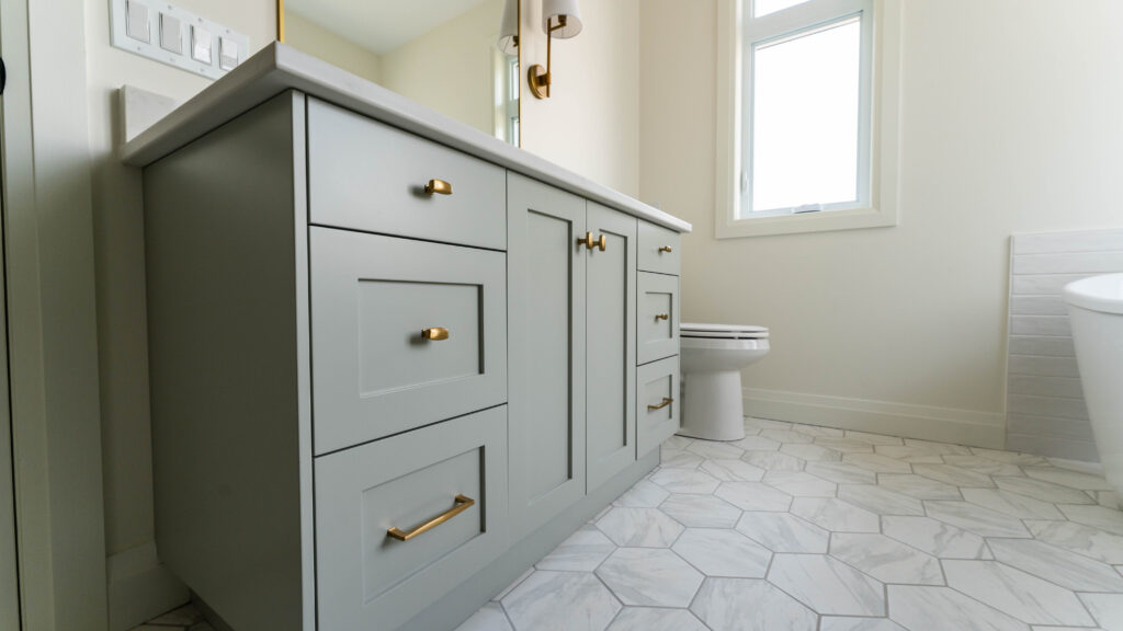 Light-grey cupboards and drawers in bathroom vanity in Sarnia, Ontario. By Sarnia Cabinets.