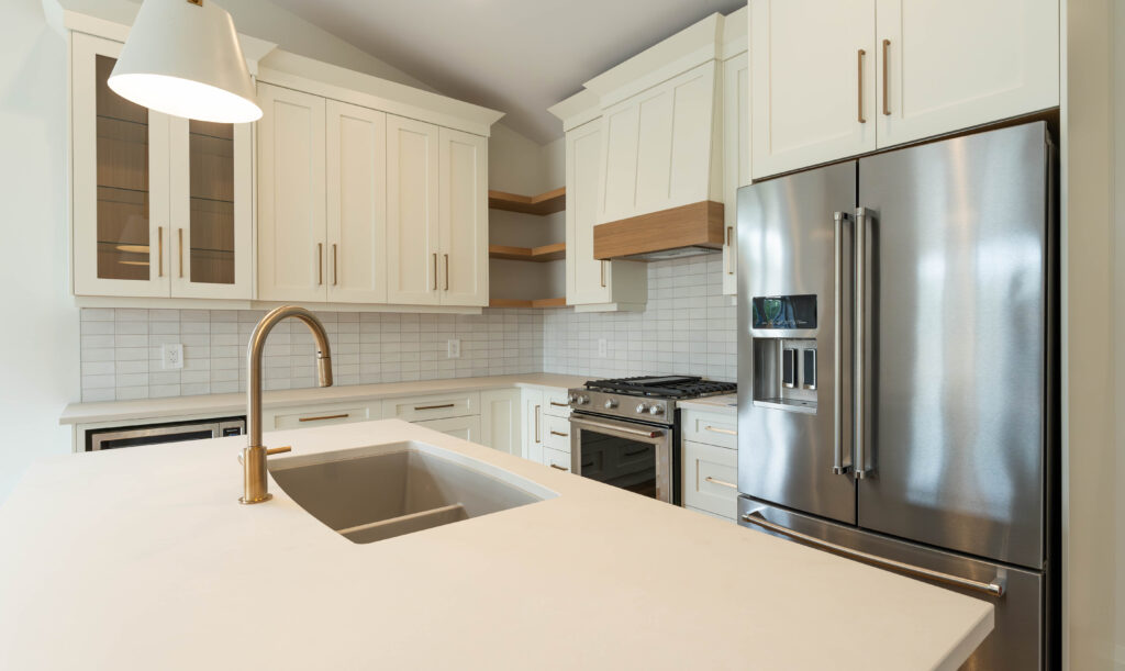 Off-white kitchen design by Sarnia Cabinets. Gorgeous upper cabinet designs with glass, cabinets and gold handles.