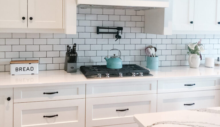 White kitchen cabinets with white tiles background in a Sarnia Cabinets kitchen