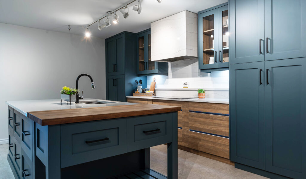 Dark blue cabinets with lights in drawers in kitchen at Sarnia Cabinets Showroom in Sarnia, Ontario.