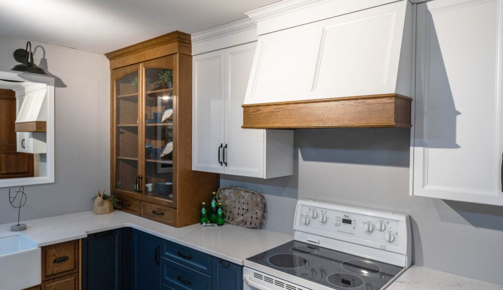 White, wood grain and blue kitchen cabinetry at Sarnia Cabinets.